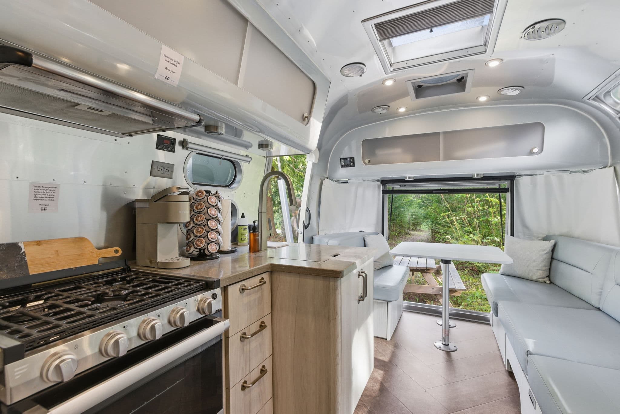 Airstream interior with full kitchen and rear dining nook