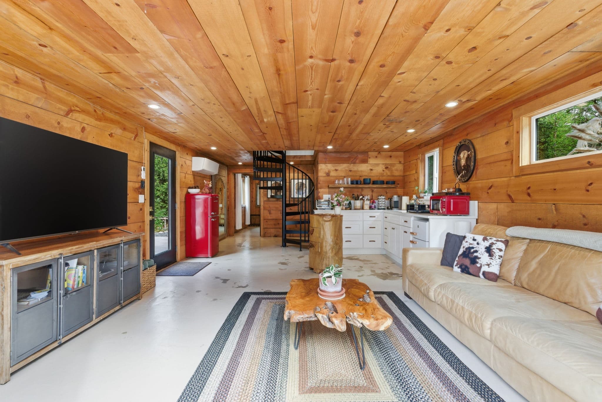 Cottage living room with spiral staircase and retro red fridge