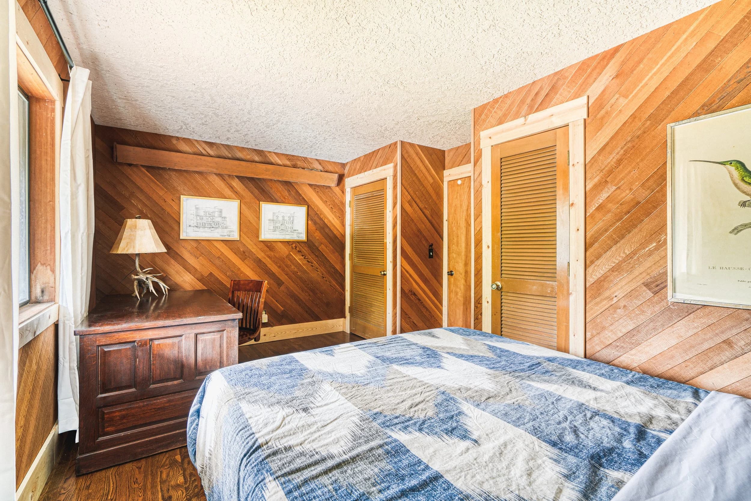 Bedroom with herringbone wood paneling