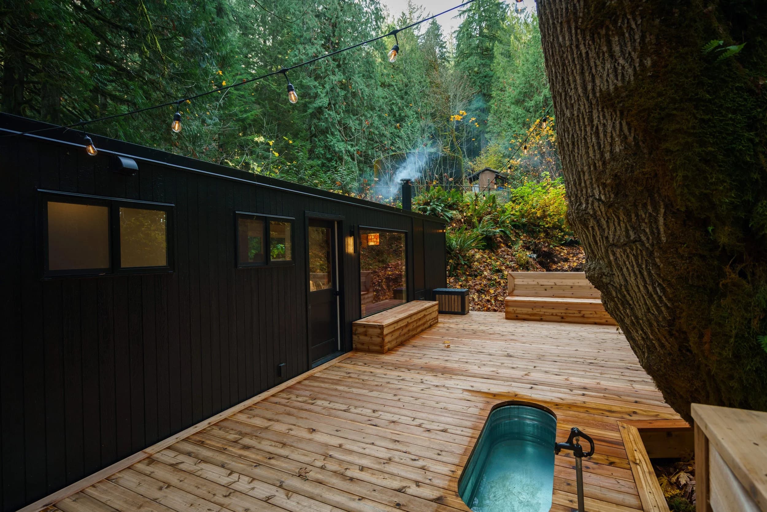 Spa deck with cold plunge tub and string lights