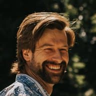 Connor, who owns Highland Farms, smiling outdoors